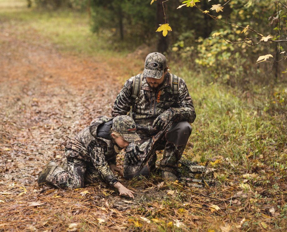 Father and son kneeling on path