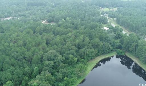 Aerial view of property's location with a forest a