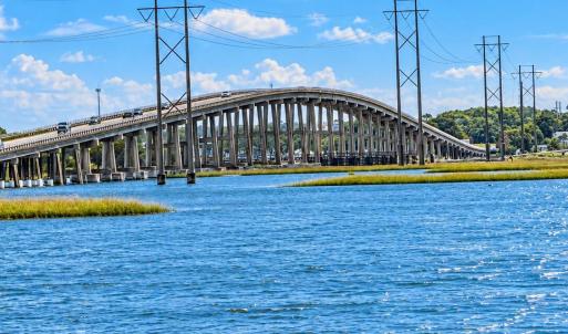 Arched Bridge Over Blue Marsh Waters