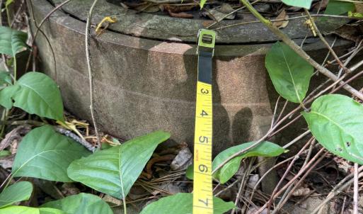 Sewer manhole showing measuring tape tou