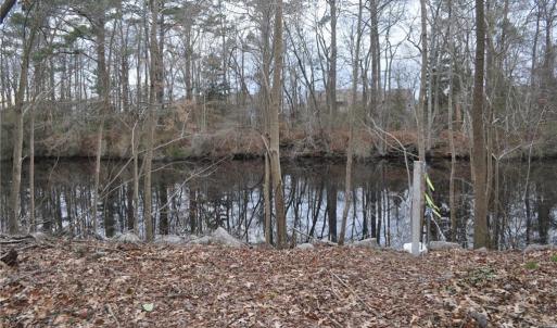 NW lot corner view with corner marked near Post