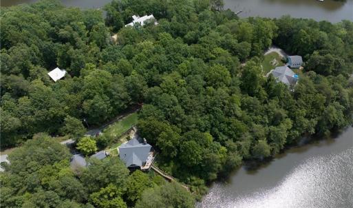Birds eye view of property with a water view