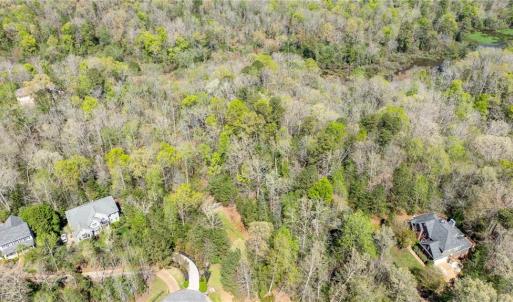 Aerial view of property from above cul de sac looking east