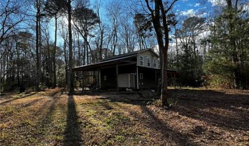 Two story barn with RV parking on the side.