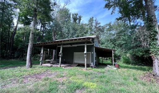 Two story barn with RV parking on the side.
