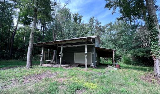 Two story barn with RV parking on the side.