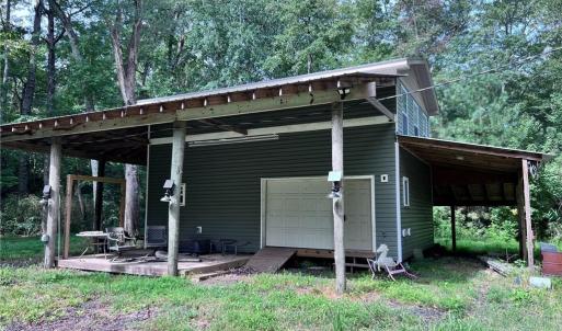 Two story barn with RV parking on the side.