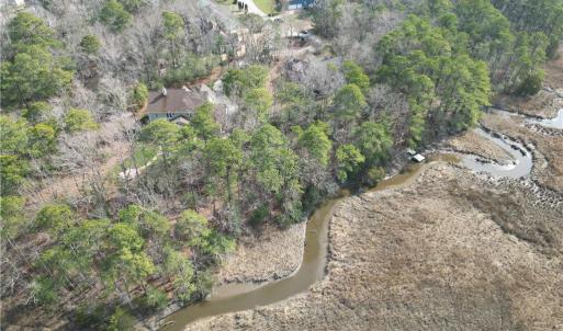 Creek extends to tip of lot