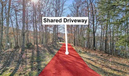 See pink flags to right and left of asphalt driveway for the marked easement.  Lot is located at end of shared driveway to the right on peninsula.