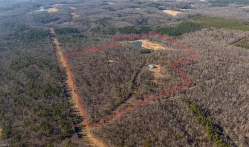 The locked red gate is located on Slate Mine Road.  This is a shared private road with 2 other property owners and the acreage for sale begins just after crossing under the powerlines ahead.