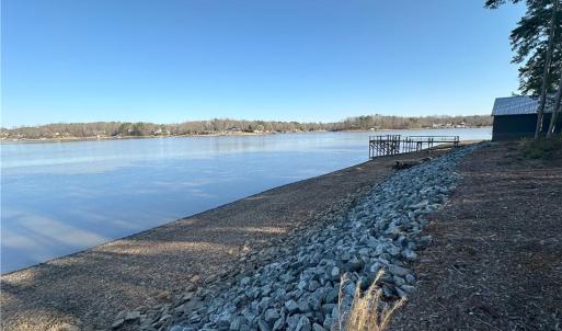 Rock riprap installed!  Temp draw down. Dock and boathouse are not included and located on lot next door NOT FOR SALE.