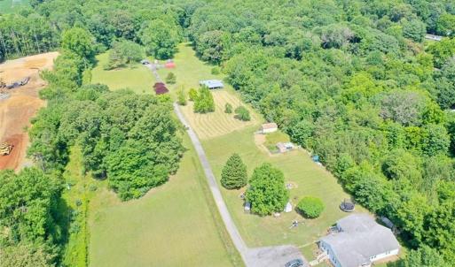 Cleared property on left with the long driveway back to the house on on right side behind the adjacent property. There are two mobile homes on this site. The property on the right side (front 2 acres) is also for sale owned by a different person.