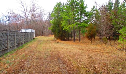 Asphalt drive ends and becomes a field.