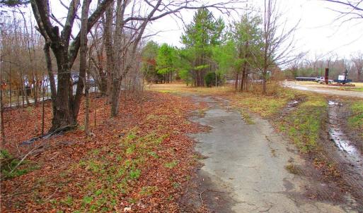 Paved asphalt drive at the entrance.