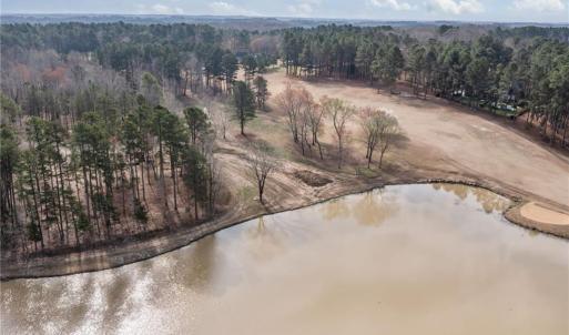 Overhead view showing the vacant land and lake. Lot lines and dimensions are approximate.