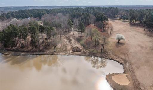 Overhead view showing the vacant lot 54 and the lake with the 18th green and fairway to the right.