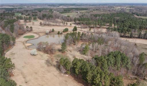 Overhead view showing the vacant land and lake.