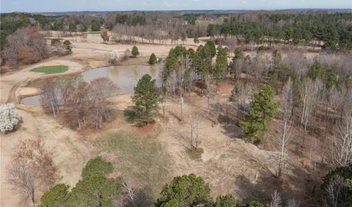 Overhead view showing the vacant land and lake.