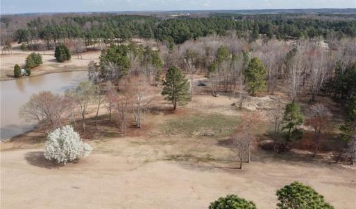 Overhead view showing the vacant land and lake.