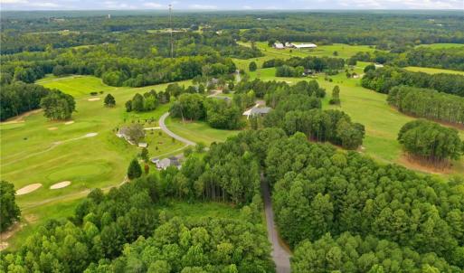 Aerial view of the neighborhood and the golf course lot.