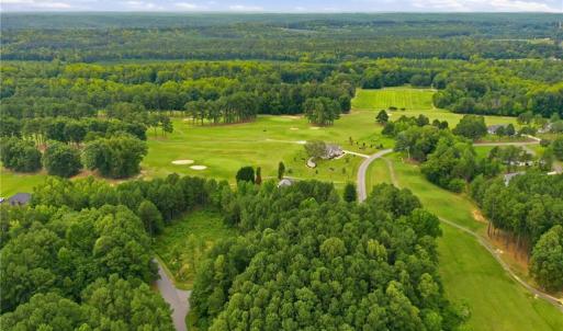 Aerial view of the neighborhood and the golf course lot.