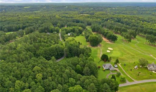 Aerial view of the neighborhood and the golf course lot.