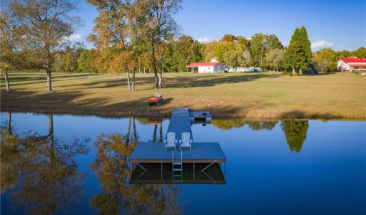 Stocked pond w/ floating dock