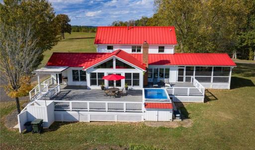 Large Trex style back deck, endless lap style pool (HydroDrive System), outdoor shower, direct access from the mudroom or great room, and views of rolling pasture and ponds