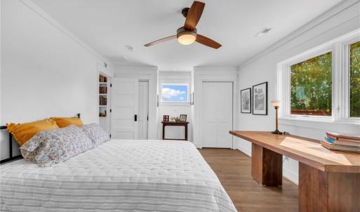 Guest bedroom w/ ceiling fan and access to nook overlooking foyer