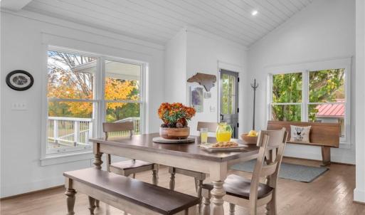 Open dining area adjacent to the kitchen & great room. Vaulted shiplap ceilings w/ exposed wood beams.