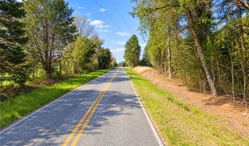 Paved Country Road Access Orange County NC Land. The paved country road that serves the land, lined with woods and fields. No dirt road to deal with for this Orange County, NC acreage for sale.