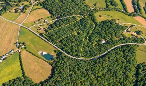 Wooded Homesite Acreage Near Chapel Hill NC. Aerial view of the 20.65 acre parcel with nearby farms and homes. Room for a private homesite, barn or mini farm in Orange County, NC. Outline approximate.