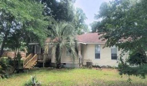Back of house featuring a yard