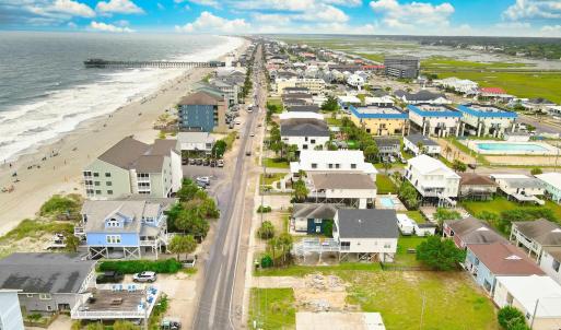 Bird's eye view with a view of the beach and a wat