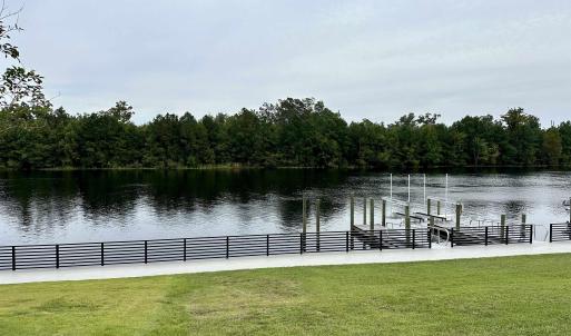 Exterior space with a lawn and a water view