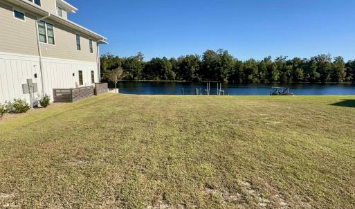 View of grassy yard with a water view