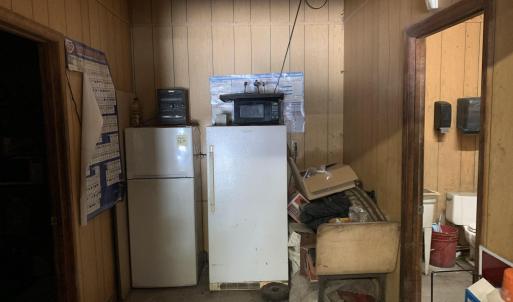 Kitchen with white refrigerator and wood walls