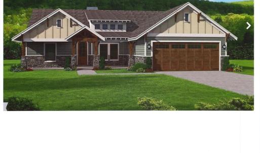 View of front of home with a front yard, a garage,