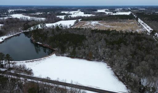 Snowy aerial view featuring a water view