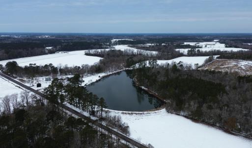 Snowy aerial view featuring a water view