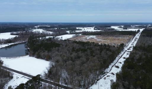 Snowy aerial view featuring a water view