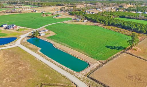 Drone / aerial view with a water view and a rural