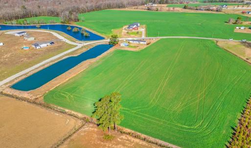 Birds eye view of property with a water view and a