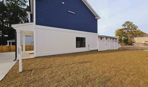 View of side of property featuring a yard