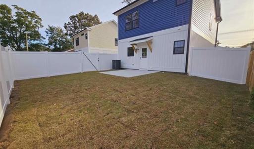 Back of property at dusk featuring a fenced backya