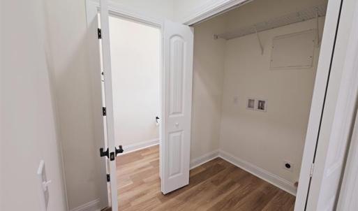 Clothes washing area with laundry area, wood finis