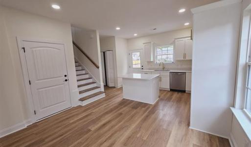 Kitchen featuring a center island, light counterto
