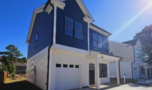 View of front of home featuring a garage, concrete