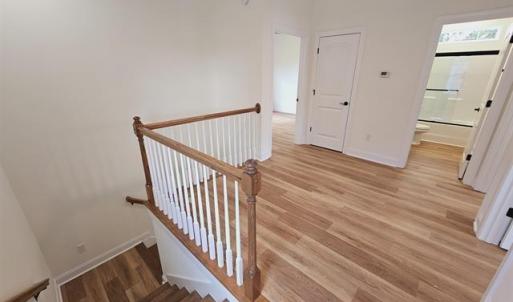 Stairs featuring baseboards and wood finished floo