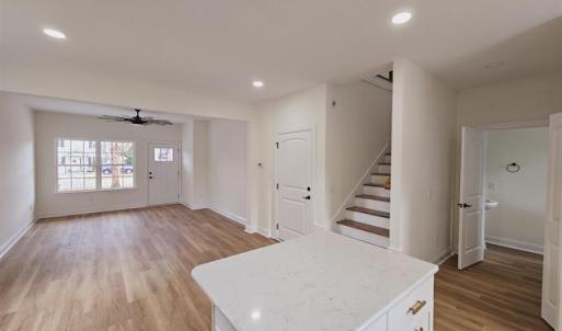 Kitchen with open floor plan, light countertops, a